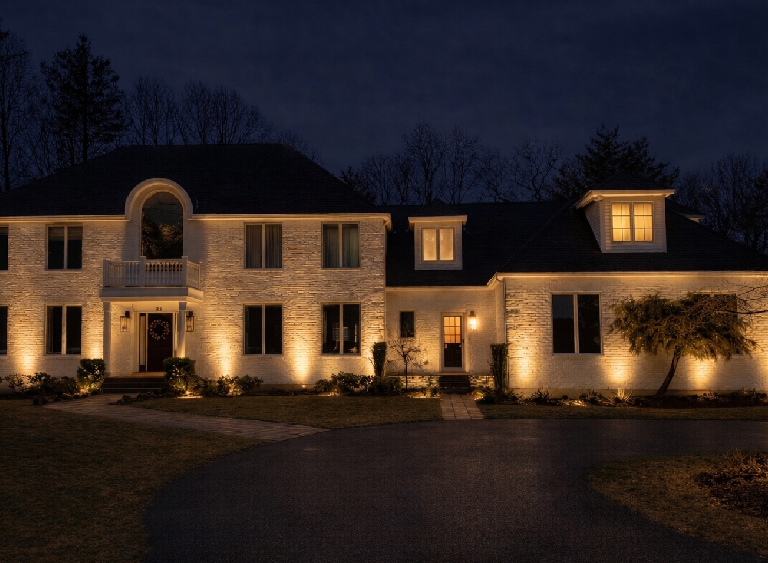 Professional outdoor lighting design illuminating a Massachusetts home at night — NightView Outdoor Lighting